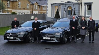 Mercedes emerald green hearse and limousine with staff